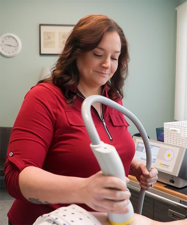 Michelle Lussier giving a SoftWave Therapy treatment